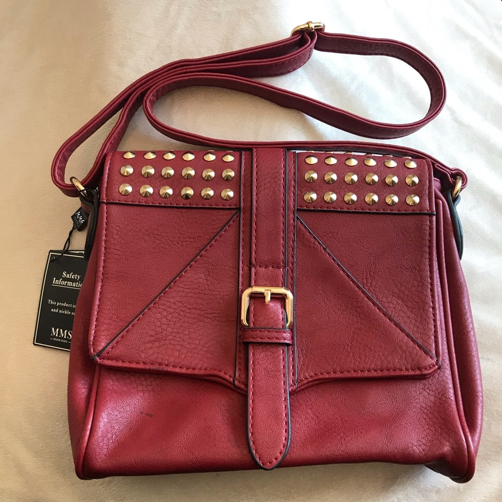 Red crossbody purse with gold studs and buckle